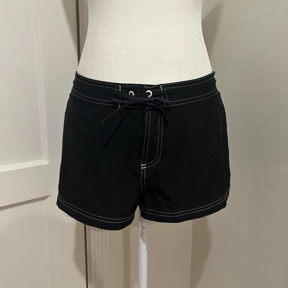Black swim low to mid rise board shorts with white stitching